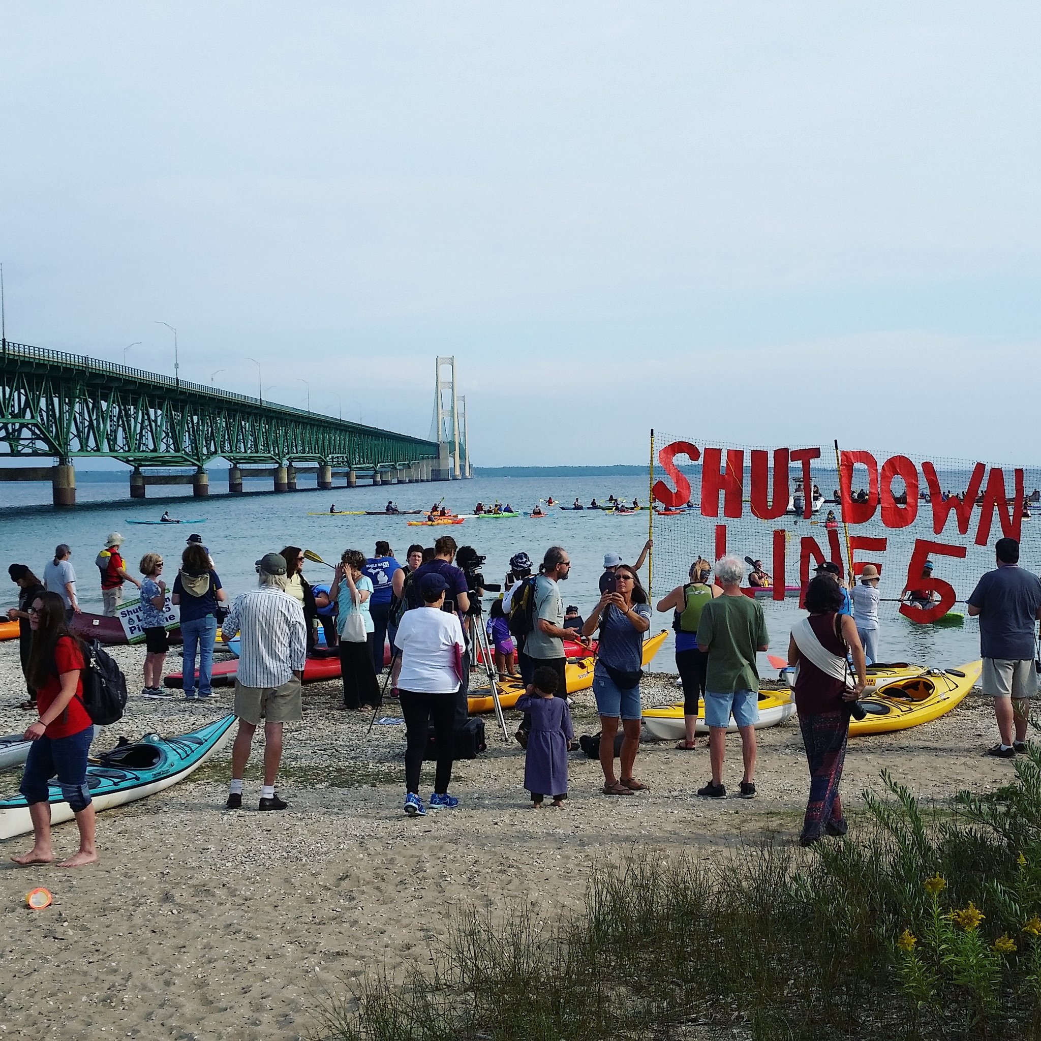 Shut Down Line 5 flotilla protest assembling under the Mackinac Bridge