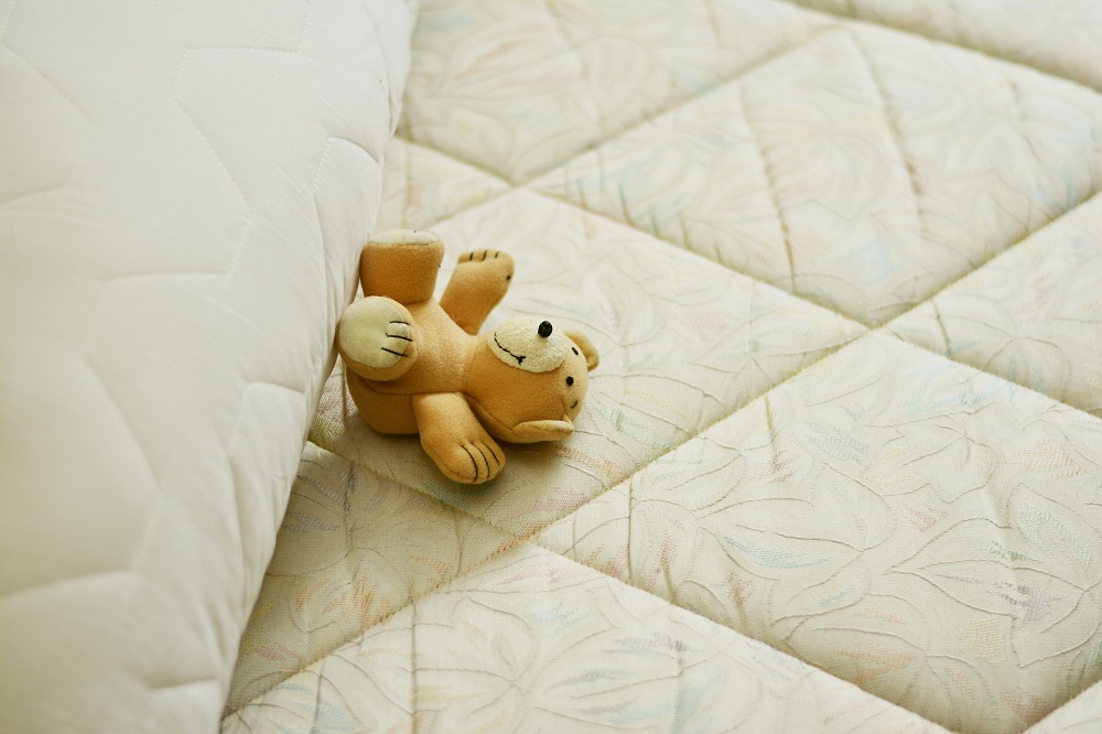 Mattress witha teddy bear on it