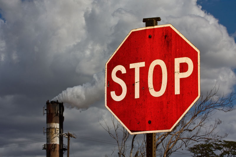 Smokestack and stop sign Smokestack and stop sign