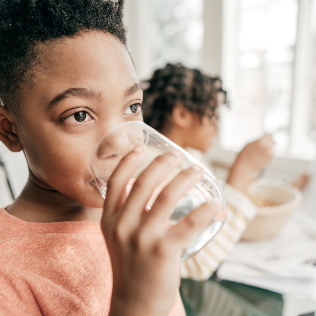 Child drinking water from glass