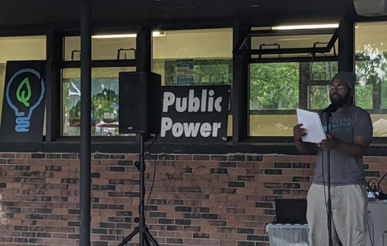 Erik McCleary at the mic at a Public Power gathering in Ann Arbor. Photo Jennifer Schlicht.